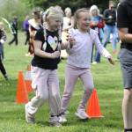 Seven-year-old friends Ruby Miller and Juliette McHugh participate in the three-legged race during the Sequim Irrigation Festivals Family Fun Days on May 3.