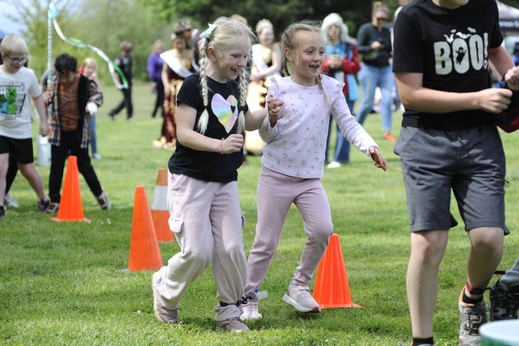 Seven-year-old friends Ruby Miller and Juliette McHugh participate in the three-legged race during the Sequim Irrigation Festivals Family Fun Days on May 3.