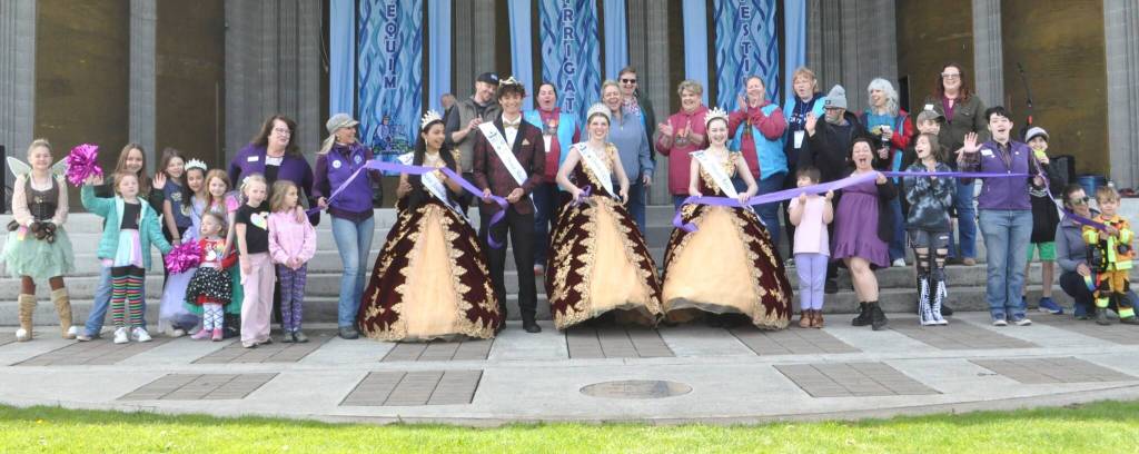 Sequim Gazette photo by Matthew Nash
Sequim Irrigation Festival royalty cut the ribbon for the festivals 130th year with community members and representatives of the Sequim-Dungeness Valley Chamber of Commerce.