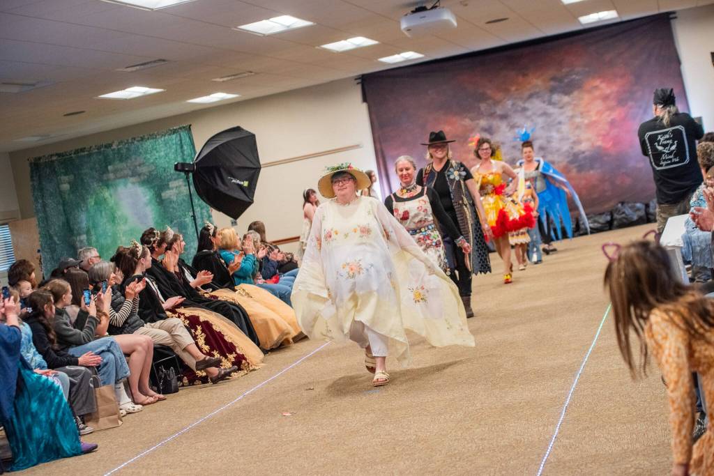 Sequim Gazette photo by Emily Matthiessen/ Taylor Downing leads other models in the Irrigation Festivals Trashion show on Sat. evening at the Guy Cole Events Center.