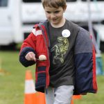 Sequim Gazette photo by Matthew Nash/ Dakota Erpenbeck, 6, of Port Angeles walks carefully with an egg in an obstacle course on May 4 at the Family Fun Days event. It was his first time visiting the Sequim Irrigation Festival, his mom said.