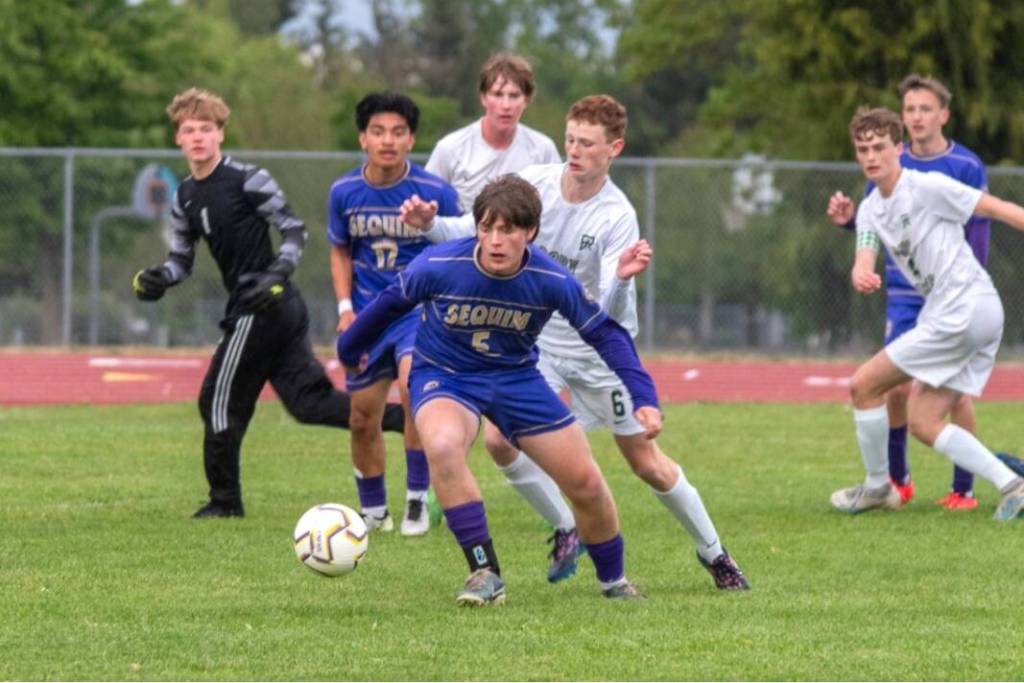 Sequim Gazette photo by Emily Matthiessen/ Sequims Finn Braaten (5) and Evan Cisneros (17) battle for the ball against Port Angeles Sawyer Davis (6). Port Angeles goalkeeper Gus Halberg (1) is also in on the play. Sequim won 1-0 Friday in Sequim.