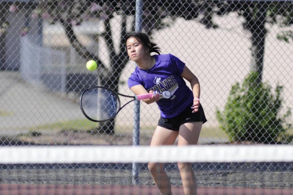 Sequim Gazette photo by Matthew Nash/ Tiffany Lam, Sequims no. 1 singles player, hits the ball on May 2 during her 6-1, 6-1 win against Bremertons Emma Murray. Sequim swept matches that day in their final regular match of the season.