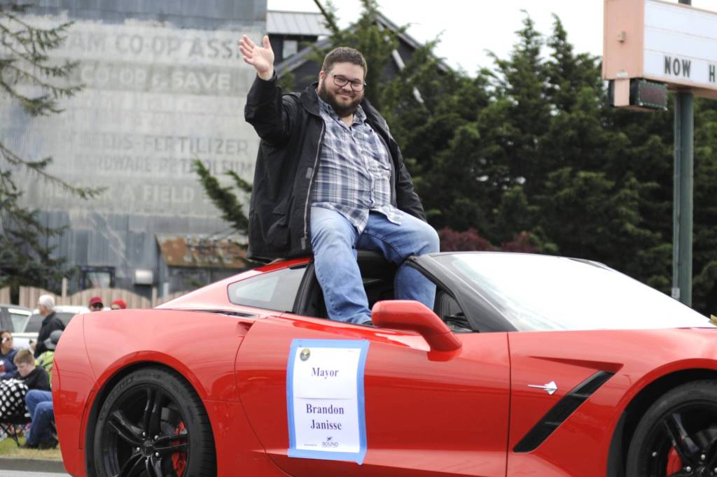 Sequim Gazette photo by Matthew Nash/ Sequim Mayor Brandon Janisse enjoys the ride in a cool car during the Grand Parade.