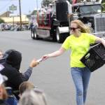 Sequim Gazette photo by Matthew Nash/ Sequim Food Bank volunteer Lily Neal hands out seeds to spectators of the Grand Parade.