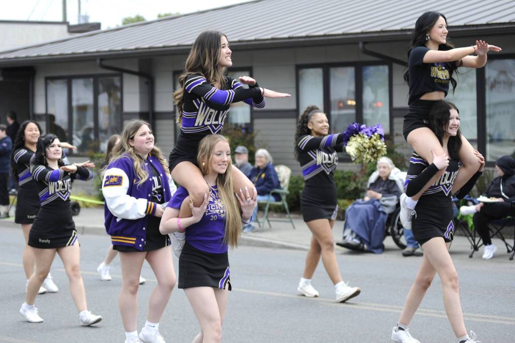 Sequim Gazette photo by Matthew Nash/ Sequim High Schools cheer squad performs a routine for the crowd near downtown Sequim.