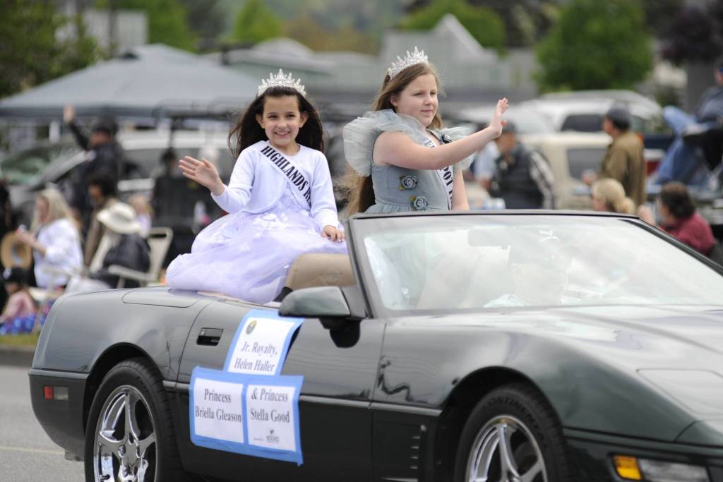 Sequim Gazette photo by Matthew Nash/ Junior Royalty princesses Stella Good and Briella Gleason wave to spectators at the Grand Parade.