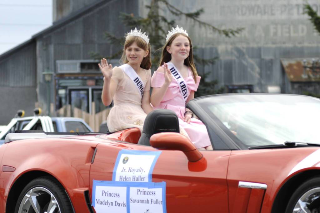 Sequim Gazette photo by Matthew Nash/ Junior Royalty princesses Madelyn Davis and Savannah Fuller wave to spectators at the Grand Parade.