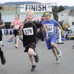 Sequim Gazette photo by Matthew Nash
Friends Kenny Johnson (179) and Miller Rose (157), both 8, run the 1-mile race for the Sequim Irrigation Festival for the first time. Kenny ran his first race at the Sequim Sunshine Festival and caught the bug, his mom said, while this was Millers first race ever, his mom said.
