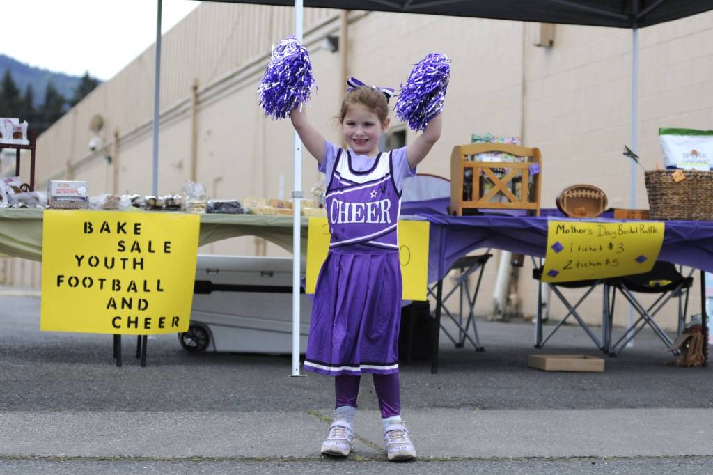 Sequim Gazette photo by Matthew Nash
Five-year-old Autumn Madison shares a cheer with passers-by of the Sequim Wolf Pack and Cheer fundraising booth during the Sequim Irrigation Festival on May 10.