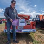 Sequim Gazette photo by Emily Matthiessen/ John Thomas shared his 1954 custom Mercury Monterey with a small block Chevy engine with folks visiting the Irrigation Festivals Car show. He holds in his hand a binder detailing the cars journey from a junkyard in San Andreas, CA. He built it out, including all the paint and body work and the upholstery was done by Rich Hawkins of Sutter Creek, Calif.