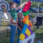 Sequim Gazette photo by Emily Matthiessen/ Duncan Burns, 11, and Sylas Plue, 7, work on a giant Tetris puzzle together at the Irrigation Festival Car Show.