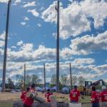 Sequim Gazette photo by Emily Matthiessen/ Contestants in Sequims Logging Show watch other contestants climb 60 foot poles last weekend.