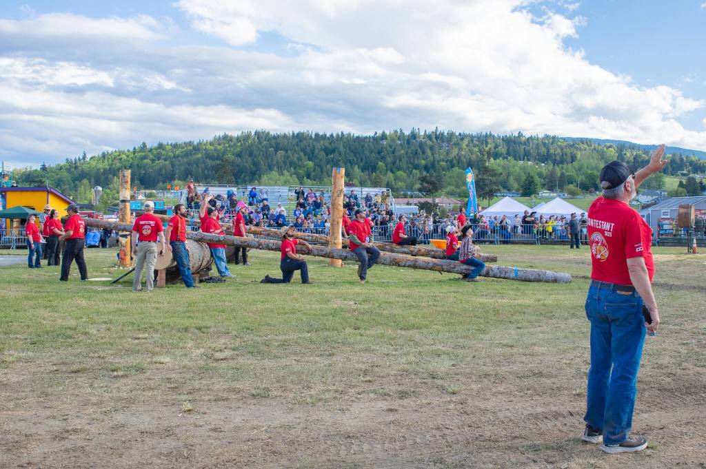 Sequim Gazette photo by Emily Matthiessen/ Contestants in Sequims Log Show watch other contestants climb 60 foot poles last weekend.
