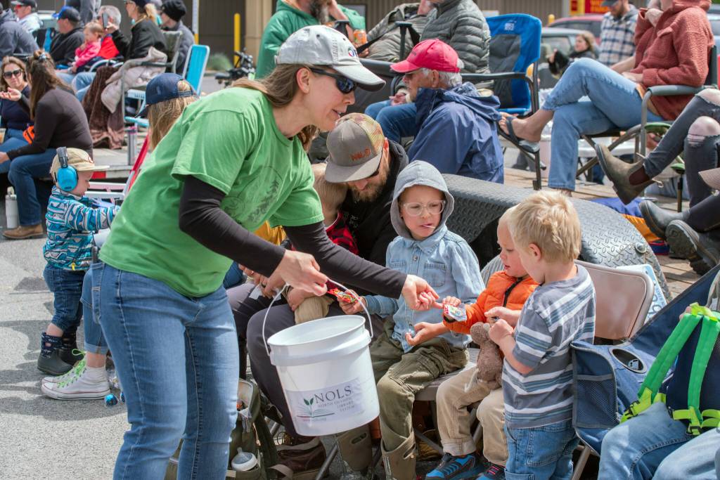 Sequim Gazette photo by Emily Matthiessen/ North Olympic Library staff and volunteers in this years special tee-shirt handed out candy to children in the crowd during Sequims Irrigation Festival Parade.