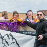 Sequim Gazette photo by Emily Matthiessen/ Anais, age 6, greets her father Oliver as she rides with the Little League of Sequim and the two of them direct their attention to other members of the family.