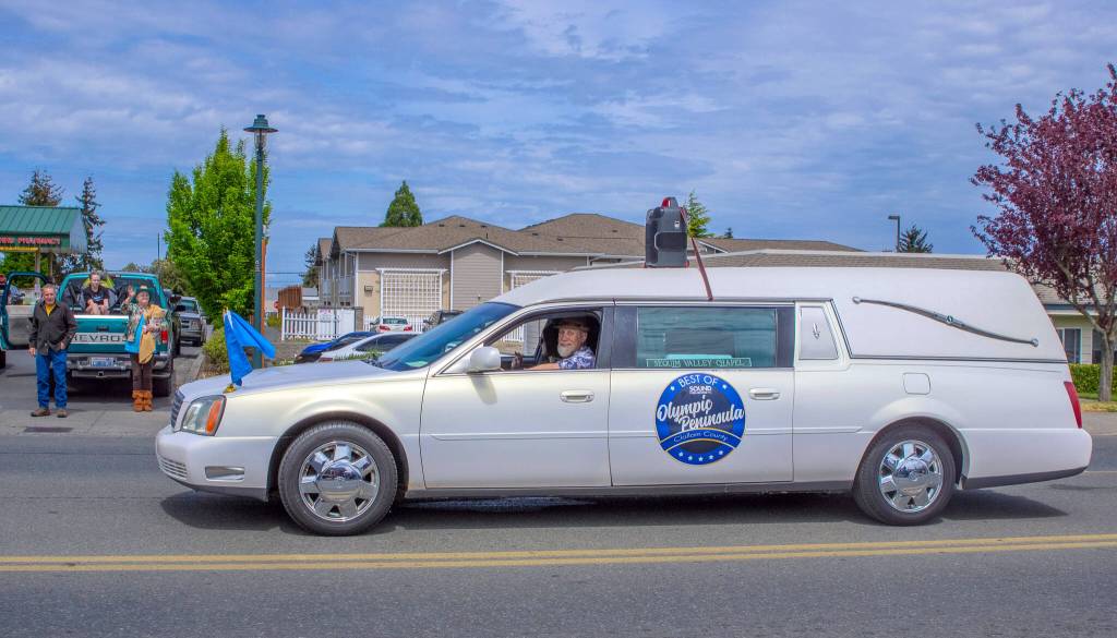 Sequim Gazette photo by Emily Matthiessen/ The last car in the lineup at the Parade was a hearse from Sequim Valley Chapel.