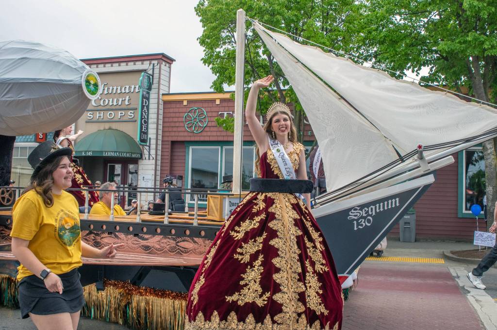 Sequim Gazette photo by Emily Matthiessen/ Queen Lily Tjemsland waves at the crowd as this years Irrigation Festival float passes down Washington Street in the parade.