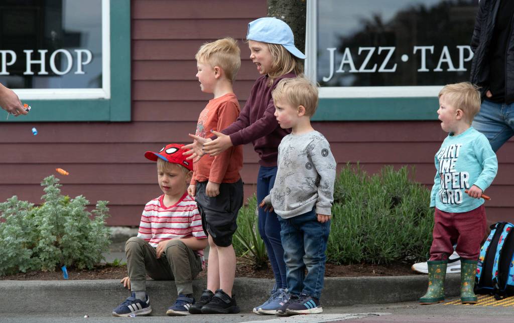 Sequim Gazette photo by Emily Matthiessen/ Theo Walgren, Henry Walgren, Aria Grubb, Noah Grubb and Danny Grubb receive candy during the Irrigation Festival Parade.