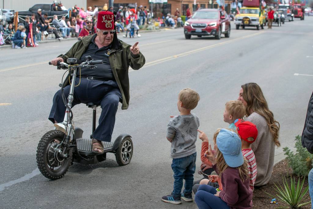 Sequim Gazette photo by Emily Matthiessen/ A Shriner greets children during the Irrigation Festival Parade.