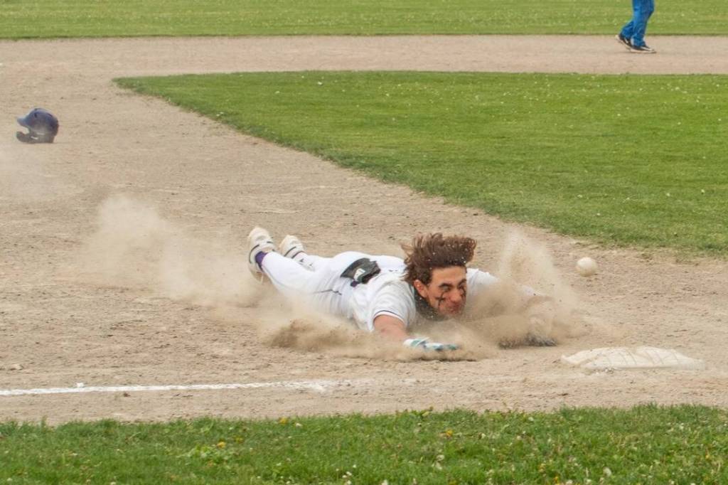 Sequim Gazette photo by Emily Matthiessen/ Sequims Bryant Laboy slides into third base for a triple against Bremerton on May 7. Sequim won the game 6-4