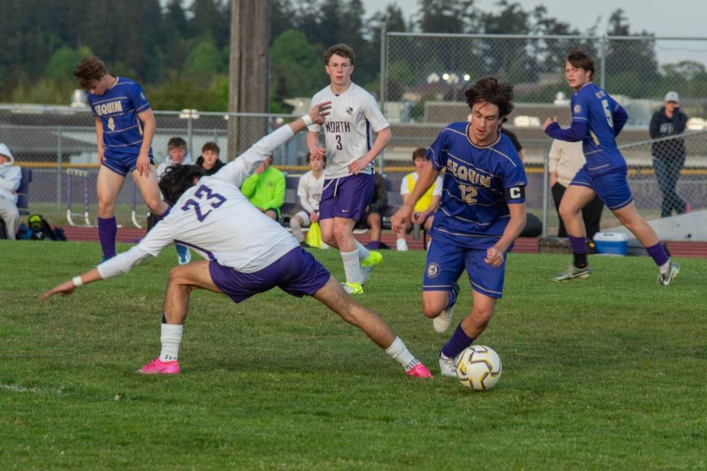 Sequim Gazette photo by Emily Matthiessen/ Josh Alcaraz drives past a North Kitsap player on May 6. The Wolves lost the regular season match 3-0, but won their first postseason game 2-1 against Steilacoom on May 10.