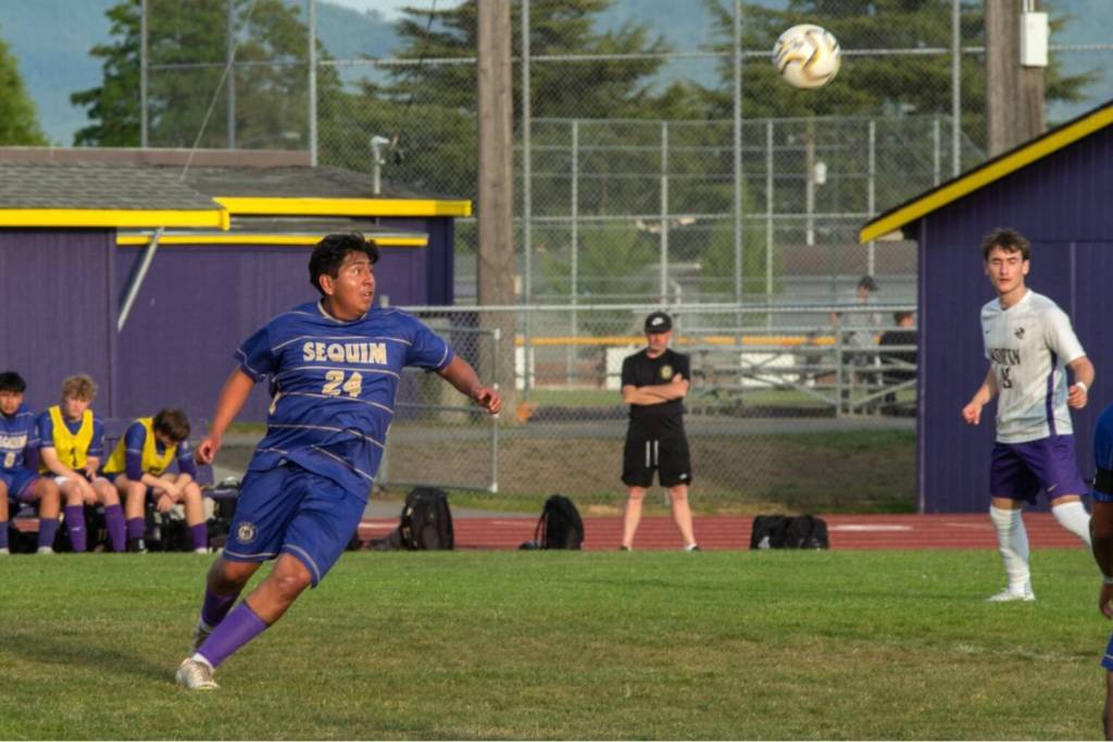 Sequim Gazette photo by Emily Matthiessen/ Adrian Mendez looks to make a big kick against North Kitsap on May 6.