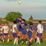 Sequim Gazette photo by Emily Matthiessen/ Sequim players head the ball near the goal against North Kitsap on May 6.