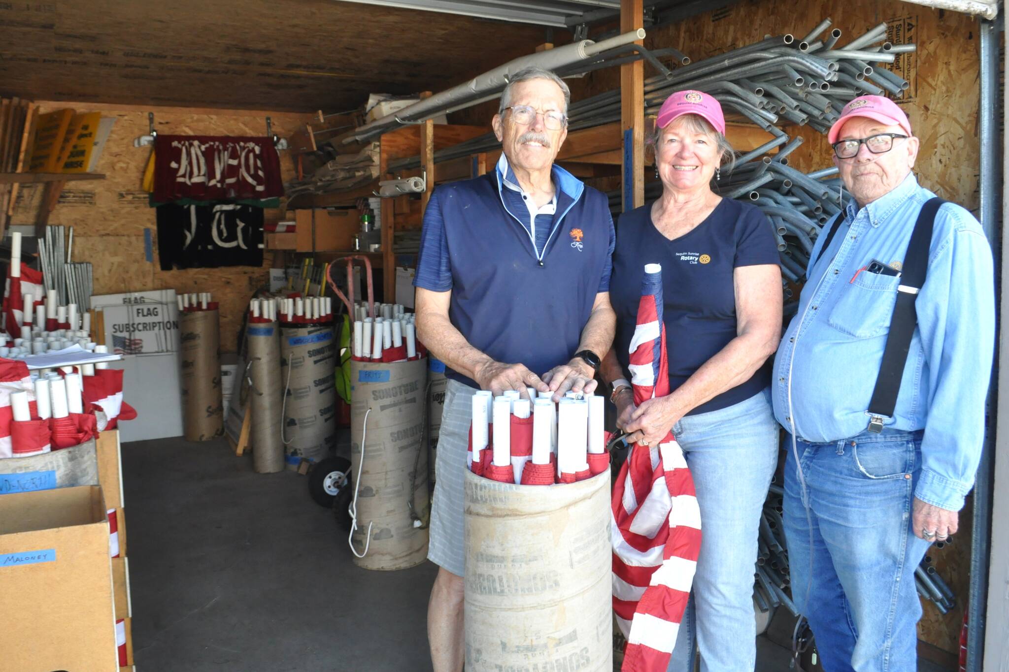 Sequim Gazette photo by Matthew Nash
Sequim Sunrise Rotarians, from left, President Bill Benedict and members Ann Flack and Charlie Johnson stand in the storage unit as they ready for Memorial Day distribution. The clubs Flag Subscription Program has more than 600 American flags that are placed across Sequim with funds going to local and international groups and projects, and high school scholarships.