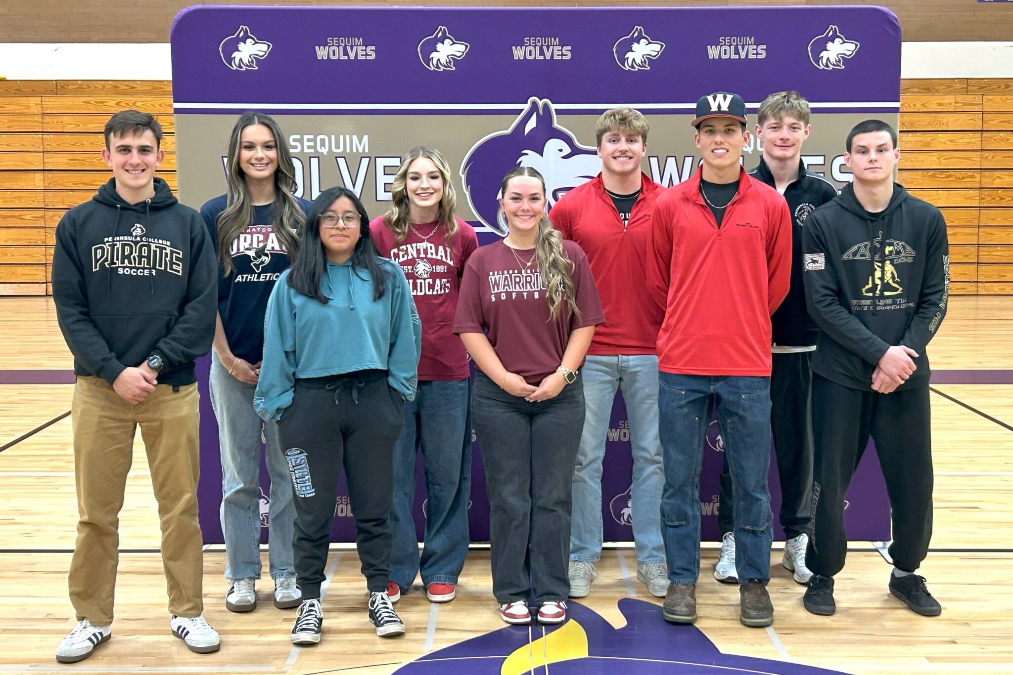 Sequim Gazette photo by Matthew Nash
Sequim High School senior athletes, from left, Nolan Valenzuela, Arianna Stovall, Aspen Goldner, Dawn Hulstedt, Mikki Green, Braydan White, Ethan Staples, Ethan Melnick, and Jayms Vilona all participated in a college commitment event on May 22. The nine students committed to play sports at six different colleges.