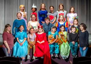 Sequim Gazette photo by Emily Matthiessen
The second-fifth grade cast of The Princess and the Pea poses for a group photo during a recent rehearsal with their Olympic Peninsula Academy teachers Dee Dee Nielsen (left) and Michele Canepa. The students will perform Friday, May 30, at 7 p.m. and Saturday, May 31, at 1:30 p.m., opening for the musical Newsies, Jr. by OPAs older drama students.