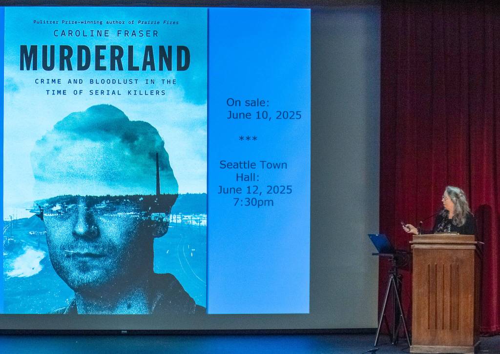 Photo by Emily Matthiessen/ Author Caroline Fraser reveals to a local audience the cover image for her new book Murderland: Crime and Bloodlust in the Time of Serial Killers shortly before its June release.