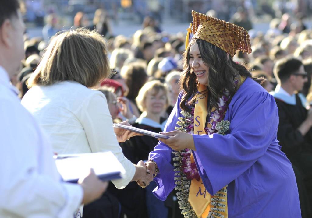 Kansas Jackson happily accepts her diploma from Sequim School Board director Patrice Johnston.