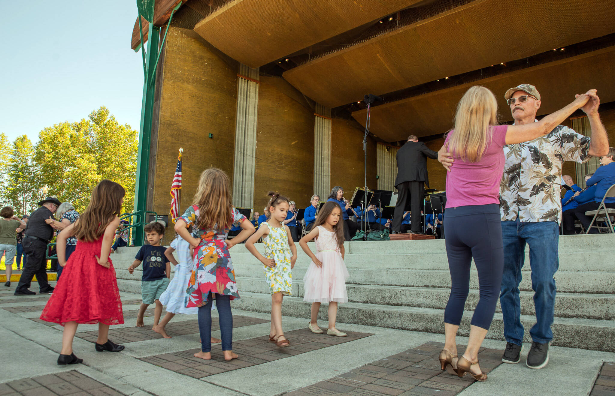 Sequim Gazette photo by Emily Matthiessen/
At the James Center for the Performing Arts band shell in Carrie Blake Community Park on Sunday afternoon, the Sequim City Band combined forces with dancers from Sequim Ballroom Dance, guest musicians, singer Sarah Shea, Olympic Theatre Arts David Herbelin and an enthusiastic audience of people and dogs who braved the heat to enjoy an outdoor concert.