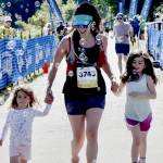 Photos by Dave Logan
Ivy Karlinsky of Seattle has her two daughters Isla, 6, and Ellie, 3, help her over the finish line during the last 20 meters of her half-marathon race at the Port Angeles Pier on Sunday.