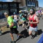 Photo by Keith Thorpe, Olympic Peninsula News Group/ Runners take off from the start of Saturdays combined 5k and 10k races of the Olympic Discovery Marathon along the Waterfront Trail from Port Angeles City Pier,