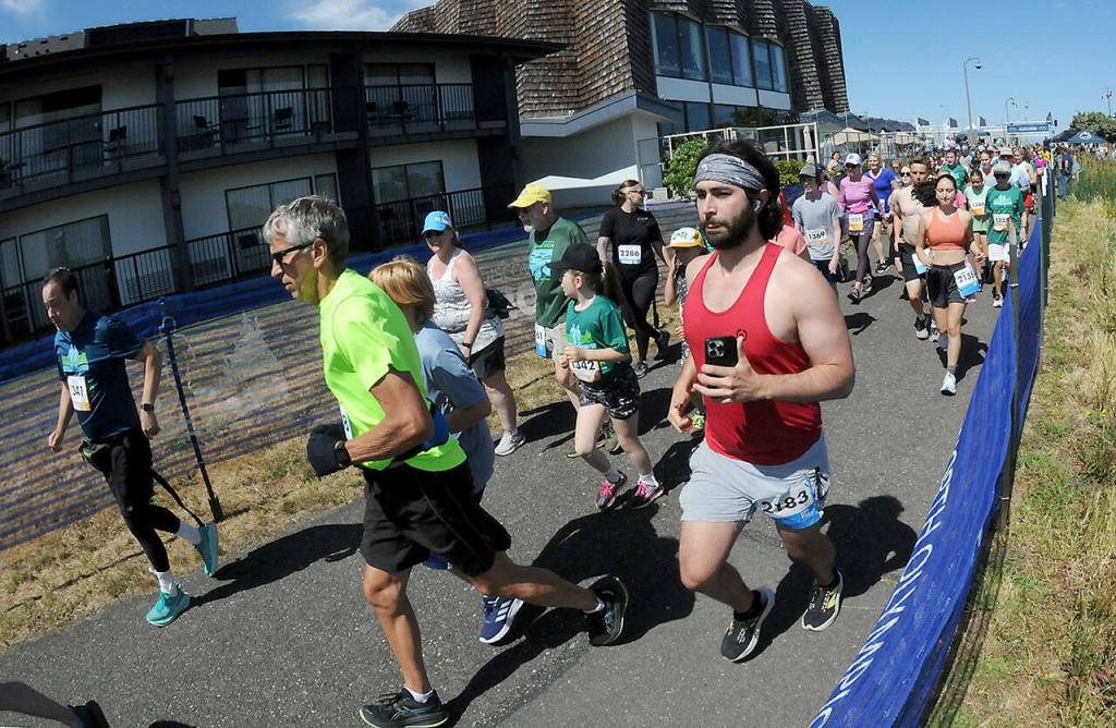 Photo by Keith Thorpe, Olympic Peninsula News Group/ Runners take off from the start of Saturdays combined 5k and 10k races of the Olympic Discovery Marathon along the Waterfront Trail from Port Angeles City Pier,