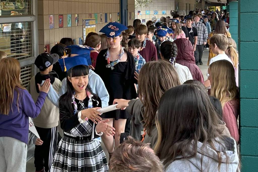 Sequim Gazette photo by Matthew Nash/ Miao Li is excited to receive a note during the June 12 Fifth Grade Moving On ceremony that honors the students moving up to middle school.