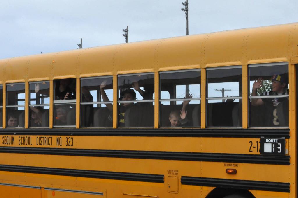 Sequim Gazette photo by Matthew Nash
Students wave goodbye for the summer to Sequim School District staff on June 12.