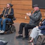 Ian Mackay, outdoors enthusiast and mobility activist, laughs at a joke made by Terry Gallagher, board member for the nonprofit Ians Ride while author Karen Polinsky looks on at the Dungeness River Nature Center.