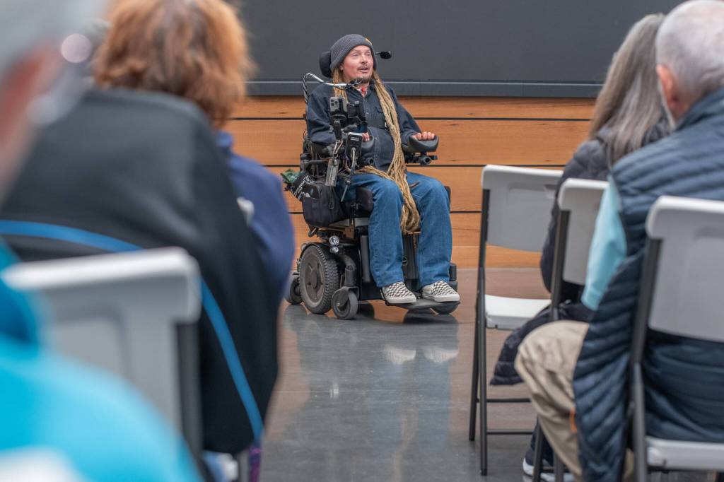 Photo by Emily Matthiessen/ Ian Mackay shares some of his journey from athletic student to quadriplegic Guiness World Record holder with an audience at the Dungeness River Nature Center last Thursday.