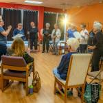 Photo by Emily Matthiessen
Singers with the Grand Olympics Chorus rehearse under the guidance of acting director Jennifer Calhoun June 9 in their cheerfully painted headquarters at 990 E. Washington St. Suite E102. They are a friendly, welcoming and joyful group who have always have room for more, according to musical director Connie Alward.