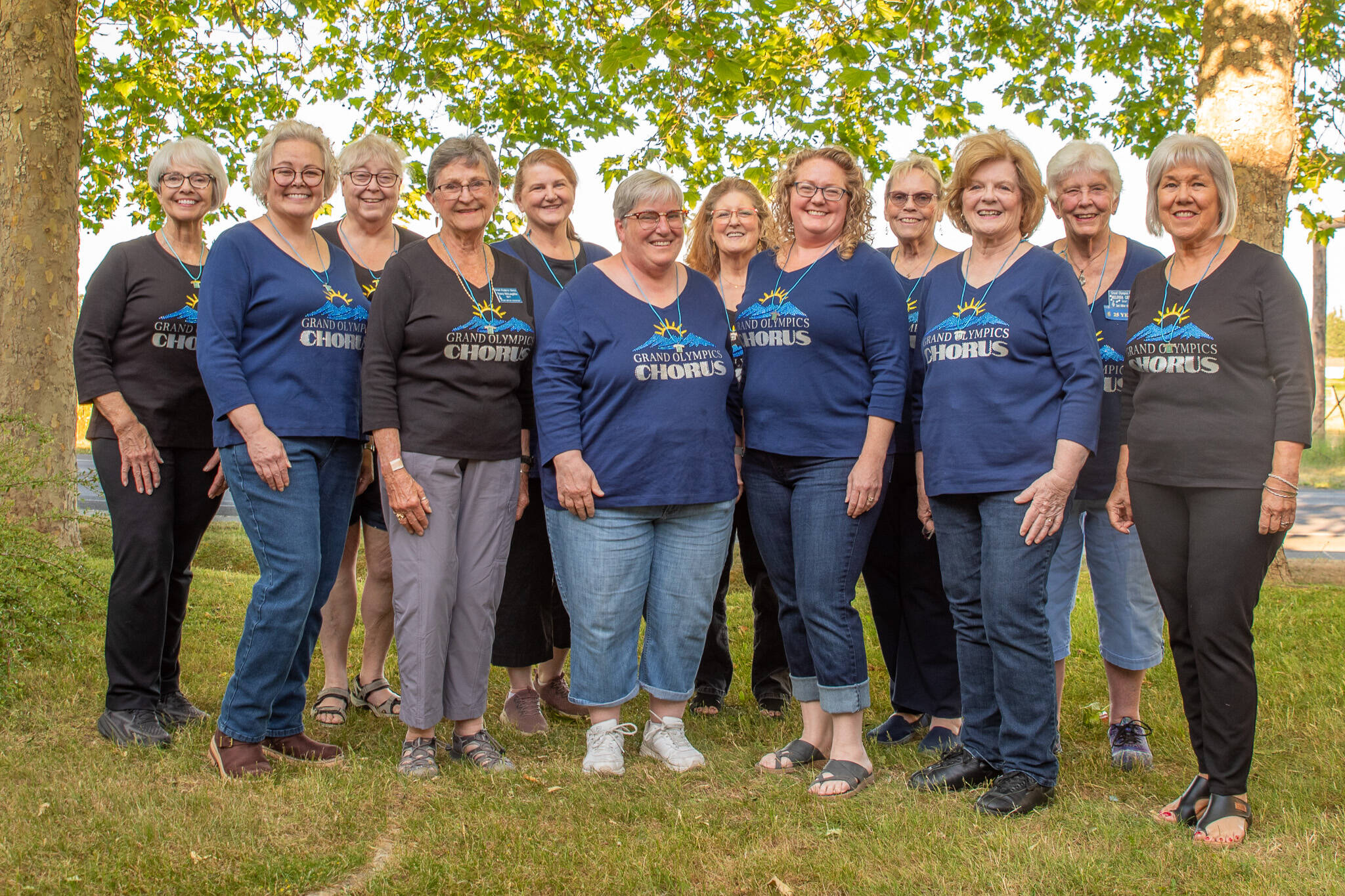 Photo by Emily Matthiessen/ Some of the 19 members of the womens barbershop Grand Olympics Chorus pose for a group photo outside their headquarters near QFC in Sequim during last weeks rehearsal wearing their Most Improved Chorus necklaces won at the Sweet Adelines Region 13 contest in Spokane in May. Group members said they have plenty of room for more singers in the chorus, and those interested are welcome to attend a Monday evening practice, either to observe or sing with them.
