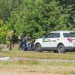 Sequim Gazette photo by Emily Matthiessen/ Justin Cox is taken into custody by law enforcement officers after he fired several rounds, striking a nearby home, while barricaded in a residence on Village Lane.