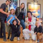 Vernon poses for a photo with diehard Elvis fans Colby and Courtney Thomas and their three children.