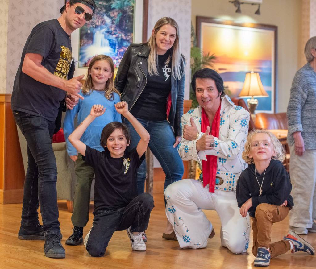 Vernon poses for a photo with diehard Elvis fans Colby and Courtney Thomas and their three children.