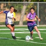 Photo by Devin Beck/ Sabrina Wilk with the NPFC Blaze moves past Raimey Brewer with the Sequim Junior Soccer U19 Queens on June 14 in Port Angeles. The Blaze won 6-0 as part of their Appreciate Night event on June 14.