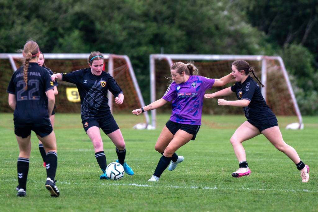 Photo by Devin Beck/ Tenille Tosland with the NPFC Blaze looks to advance the ball past a swarm of players with the St. Paul U19 Blackhawks on June 19. The Blaze won the match in Sequim 1-0.