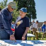 Sequim Gazette photo by Emily Matthiessen / Jeff Brown, left, and Sandra Granun discuss silent auction items at the Sequim Valley Lions 12th Annual Crab feed held in Pioneer Park on Saturday. There was an outpouring of support from local businesses resulting in a large amount of items in the auction, many of which were won at a low price by attendees. The Lions use everything beyond costs of charity, according to new member Brown, including such things as building handicap ramps for people who cant afford them, which he said is the reason he joined the nonprofit. The things we contribute to, its phenomenal, Brown said.