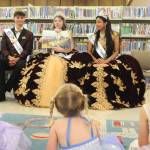 Sequim Gazette photo by Matthew Nash
Sequim Irrigation Festival royalty, from left, Prince Malachi Byrne, Queen Lily Tjemsland, and Princess Joanna Morales read the book Princess Unlimited to a crowd of young readers on July 1 at Storytime with the Royal Court at the Sequim Library Temporary Location.